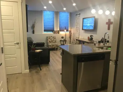 a kitchen with a sink and a cross on the wall at Home Sweet Condo in Calgary