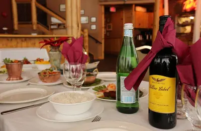 a table with a bottle of wine and plates of food at Fernie Stanford Resort in Fernie