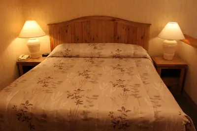 a bedroom with a bed with two lamps on tables at Fernie Stanford Resort in Fernie