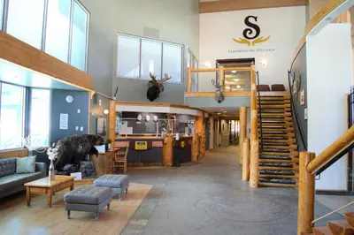 a living room with a staircase in a building at Fernie Stanford Resort in Fernie