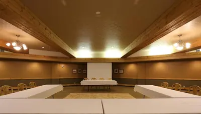 a conference room with tables and chairs and lights at Fernie Stanford Resort in Fernie