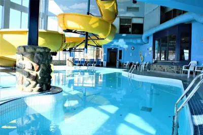 a swimming pool with a slide in a building at Fernie Stanford Resort in Fernie