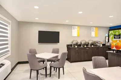 a waiting room at a fast food restaurant with a table and chairs at Days Inn by Wyndham Wainwright in Wainwright