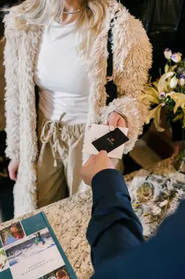 a person taking a picture of a woman at Mountain Side Hotel Whistler by Executive in Whistler