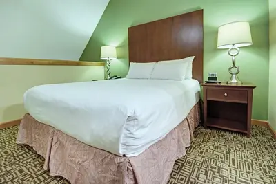 a large white bed in a hotel room at Mountain Side Hotel Whistler by Executive in Whistler