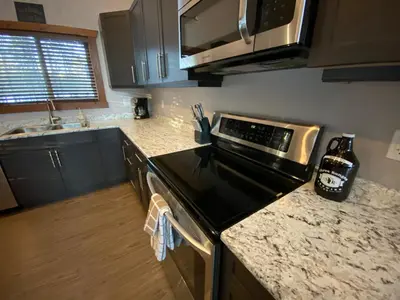 a kitchen with a stove and a counter top at Wolf Den in Valemount
