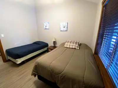 a bedroom with two beds and a window at Wolf Den in Valemount