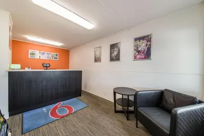 a waiting room with a couch and a table at Motel 6-Cranbrook, BC in Cranbrook