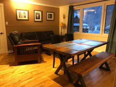 a living room with a table and a couch at Canadian Rockies Inn - Adults only in Field