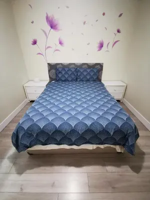 a bedroom with a bed with purple flowers on the wall at Metropolis MetroTown Area lovely place 2 or 1 bedrooms suite in New Westminster