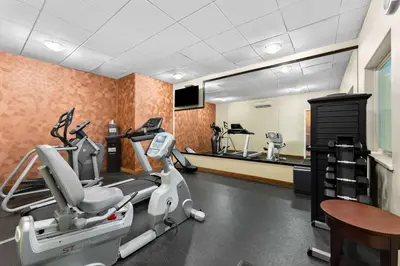 a fitness room with a treadmill and a mirror at Best Western Williams Lake in Williams Lake