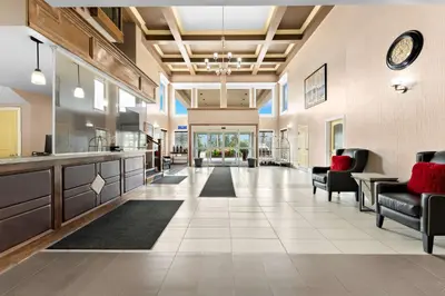 an open living room with a kitchen and a lobby at Best Western Williams Lake in Williams Lake