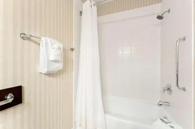 a bathroom with a shower with a white shower curtain at Best Western Williams Lake in Williams Lake
