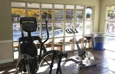 a gym with two exercise bikes next to a window at #433 The Aspens On Blackcomb in Whistler