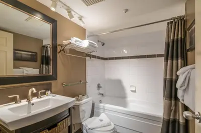 a bathroom with a sink and a tub and a toilet at #433 The Aspens On Blackcomb in Whistler