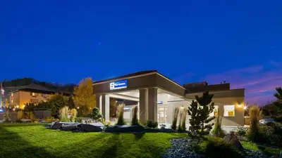 a large building in a yard at night at Best Western Mountainview Inn in Golden