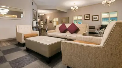 a living room with couches and chairs and a table at Best Western Mountainview Inn in Golden