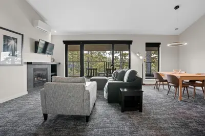 a living room with a couch and chairs and a table at Black Rock Oceanfront Resort in Ucluelet