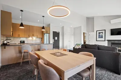 a kitchen and living room with a table and a couch at Black Rock Oceanfront Resort in Ucluelet