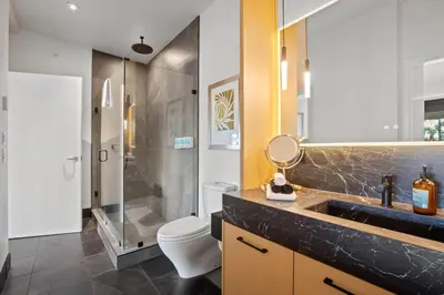 a bathroom with a shower and a toilet and a sink at Black Rock Oceanfront Resort in Ucluelet