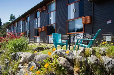two chairs and a table in front of a building at The Spot at Porpoise Bay in Sechelt