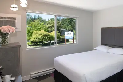 a hotel room with a bed and a window at The Spot at Porpoise Bay in Sechelt