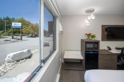 a room with a bed and a window at The Spot at Porpoise Bay in Sechelt