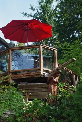 a statue of a person with a red umbrella at Tranquility Bay Waterfront Inn in Sechelt