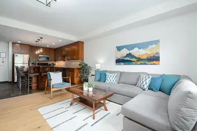 a living room with a couch and a table at Heavenly Mountain Condo managed by Little Sister Getaways in Canmore
