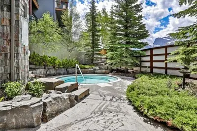 a swimming pool in the backyard of a house at Heavenly Mountain Condo managed by Little Sister Getaways in Canmore