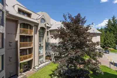 an apartment building with a tree in front of it at The Marquise by Whistler Premier in Whistler