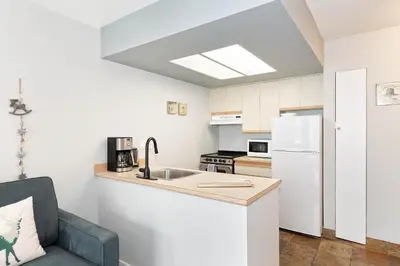 a kitchen with a sink and a white refrigerator at The Marquise by Whistler Premier in Whistler