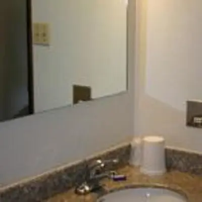 a bathroom with a sink and a mirror at Pleasant Valley Motel Houston in Houston