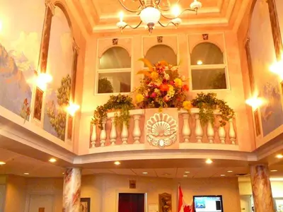a building with a balcony with flowers on it at Coast Abbotsford Hotel & Suites in Abbotsford