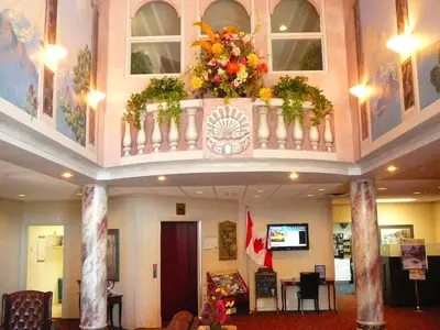 a lobby with a balcony with flowers on it at Coast Abbotsford Hotel & Suites in Abbotsford