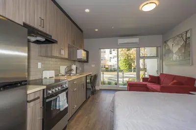 a kitchen with a red couch in a room at SoLo Suites in Victoria