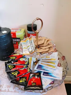 a glass table topped with a basket of chips and books at Helen's House / Close to Skytrain and Airport in Vancouver