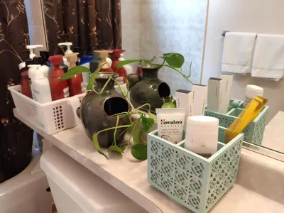 a bathroom counter with vases and other products on it at Helen's House / Close to Skytrain and Airport in Vancouver