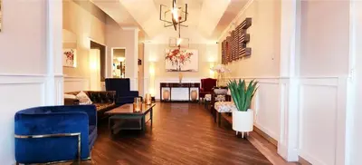 a living room with a blue couch and chairs at Western Lodge in Kimberley