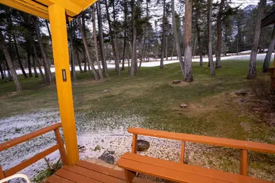 a wooden bench sitting on the porch of a house at Fairmont Hot Springs Resort in Fairmont Hot Springs