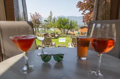 a table with two glasses and some drinks on it at Fairmont Hot Springs Resort in Fairmont Hot Springs