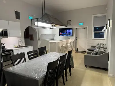 a dining room and kitchen with a table and chairs at Inntowne Motel in Hope