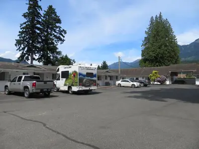 a truck parked in a parking lot with an rv at Skagit Motel in Hope