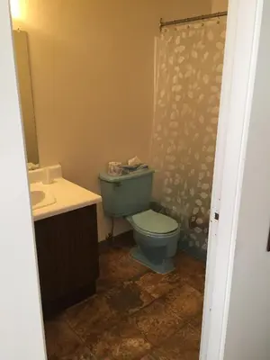 a bathroom with a blue toilet and a sink at Spring Villa Hotel in Harrison Hot Springs