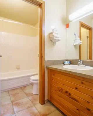 a bathroom with a sink and a tub and a toilet at The Crossing in Saskatchewan River Crossing