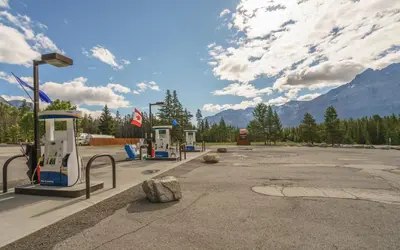 a group of gas pumps in a parking lot at The Crossing in Saskatchewan River Crossing