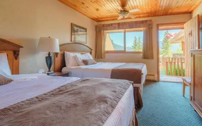 a hotel room with two beds and a window at The Crossing in Saskatchewan River Crossing