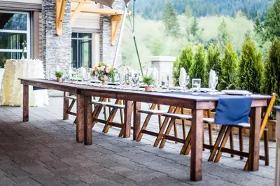 a wooden table with chairs on a patio at Executive Suites Hotel and Resort, Squamish in Squamish