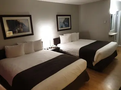 a hotel room with two beds in a room at Island View Lodge in Powell River