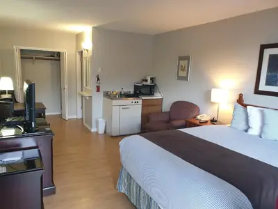 a hotel room with a bed and a television at Island View Lodge in Powell River